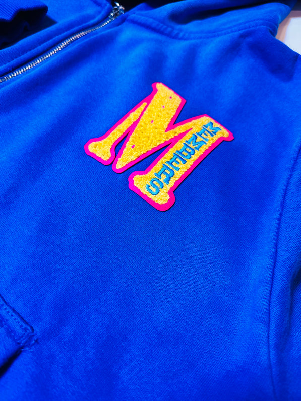 Blue jacket with a colorful 'M' logo on a white background
