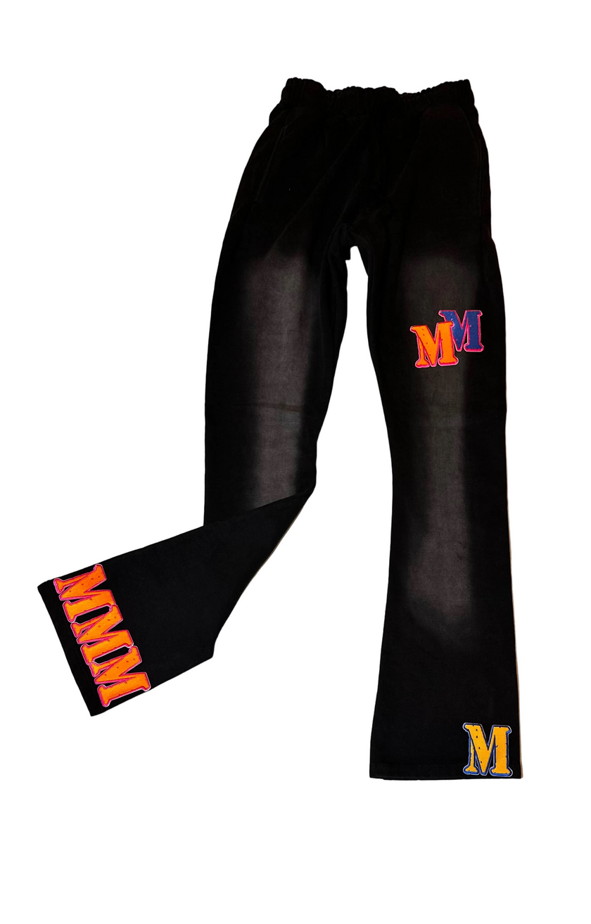 Black leggings with colorful 'M' logos on a light background